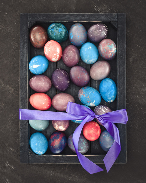 top view of painted easter eggs in gift box with bow - Фото, зображення