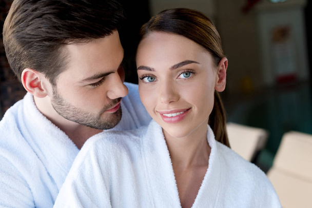 happy young couple in bathrobes resting together in spa center - Photo, Image
