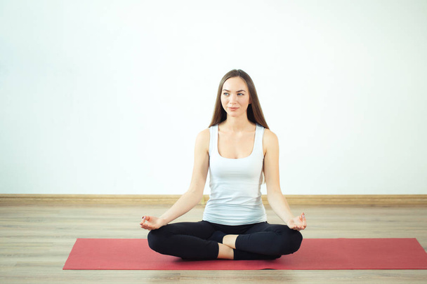 Young woman meditates while practicing yoga - Valokuva, kuva