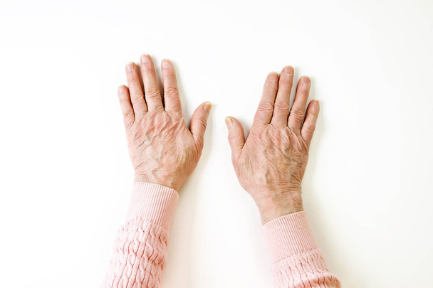 Senior female gesture language, hands signs isolated on solid white background. Old female in her seventies / eighties showing arms forearms. - Foto, Imagem