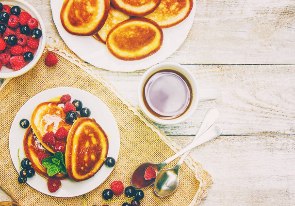 Pancakes for tea with honey and berries. Selective focus. - Photo, Image