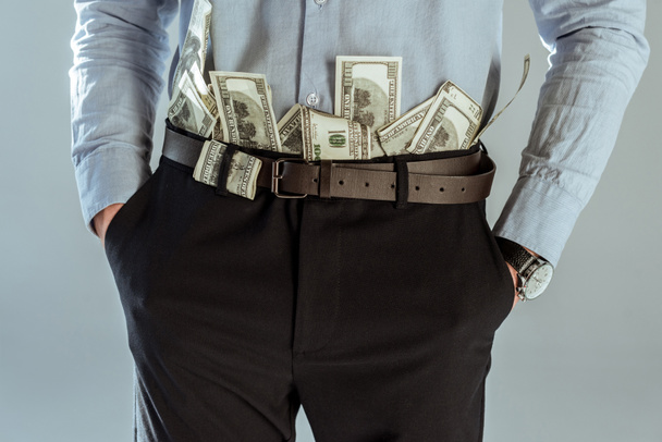Close-up view of dollar bills in businessman's pants - Valokuva, kuva
