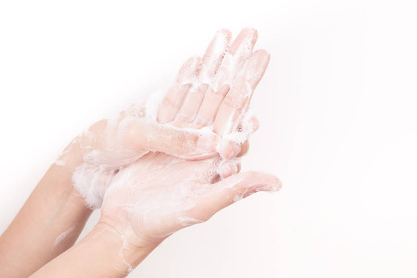 Asian girl hands are washing with soap bubbles on white background - Foto, immagini