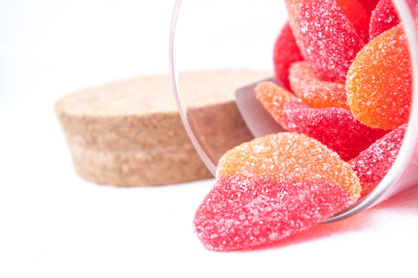 shaped heart candies falling from transparent glass container - Photo, Image