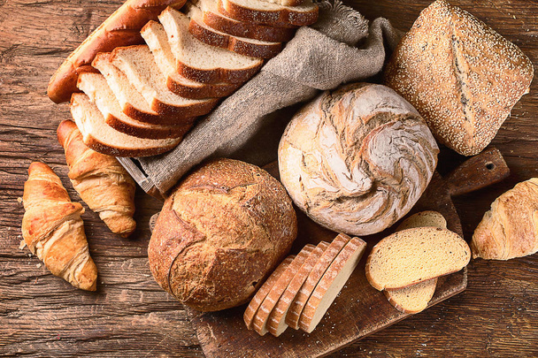 Fresh baked bread on rustic wooden background - Φωτογραφία, εικόνα