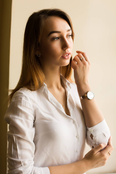 stylische brünette Frau im weißen Hemd posiert auf dem Zimmer - Foto, Bild