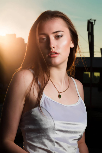 Fashionable young woman with perfect makeup posing in sun glare - Photo, Image