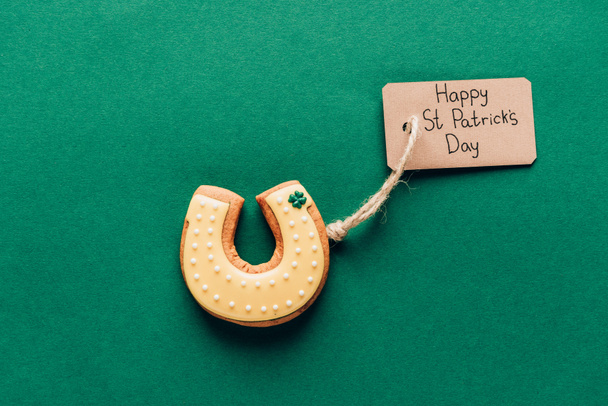 top view of icing cookie in shape of horseshoe on green, st patricks day concept - Photo, Image
