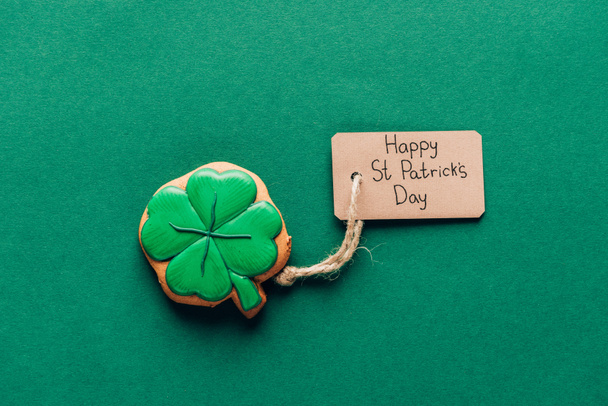 top view of icing cookie in shape of shamrock on green, st patricks day concept - Foto, immagini