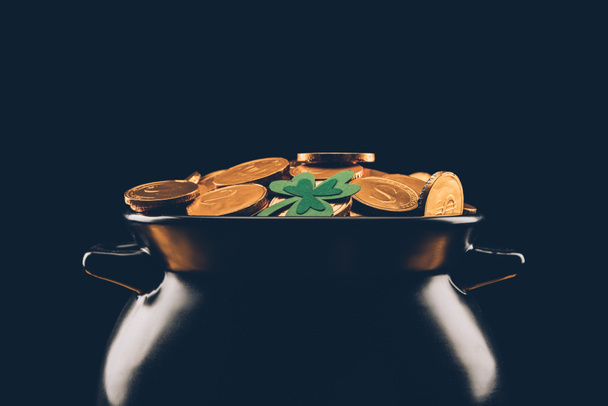 black pot with golden coins isolated on black, st patricks day concept - 写真・画像