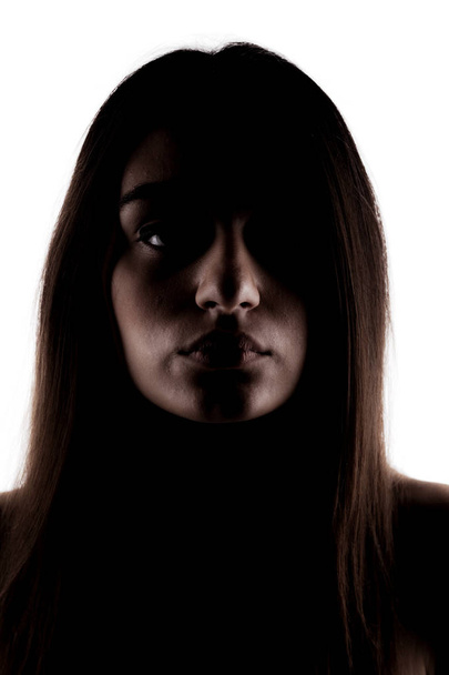 half silhouette of a brunette girl looking at camera - Valokuva, kuva