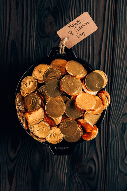 top view of pot with golden coins on wooden table, st patricks day concept - 写真・画像