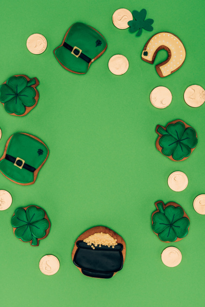 top view of icing cookies and golden coins isolated on green, st patricks day concept - Photo, Image