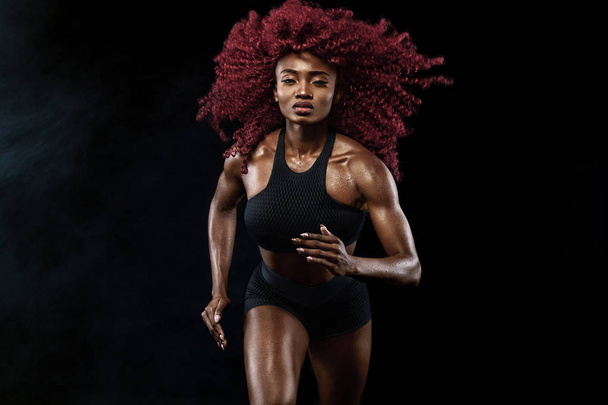 A strong athletic, female sprinter, running at sunrise wearing in the sportswear, fitness and sport motivation concept with copy space. - Photo, Image