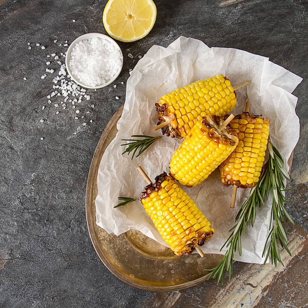 Corn grilled with salt and spices. Dark background. Fast food in - Valokuva, kuva
