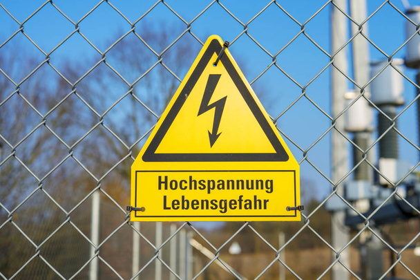 Yellow sign high voltage Danger to life - Photo, Image