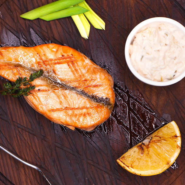 Glazed salmon fillet with sesame close up on a wooden plate - Φωτογραφία, εικόνα