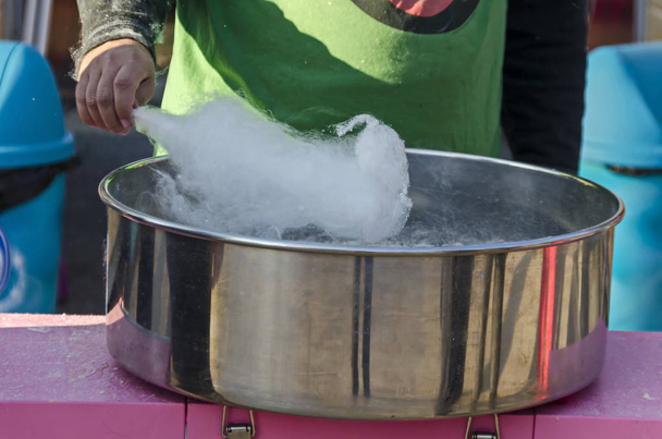 Making cotton candy in metal container at park, Sofia, Bulgaria   - Photo, Image