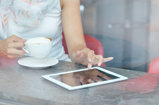 Woman use a touch pad screen while standing in cafe - Photo, Image