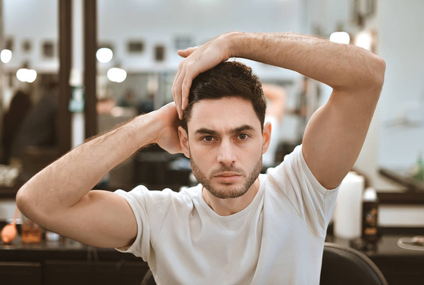Handsome man getting ready in the barbershop. - Photo, image
