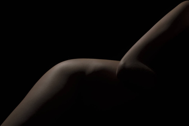Silhouette of a body part , nude woman isolated on black background - Foto, Imagem