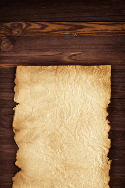 Clean sheet of crumpled paper on a wooden surface background - Photo, Image