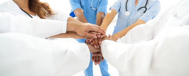 Doctors and nurses in a medical team stacking hands - Фото, зображення