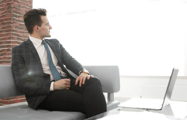 successful businessman sitting on office sofa - Zdjęcie, obraz
