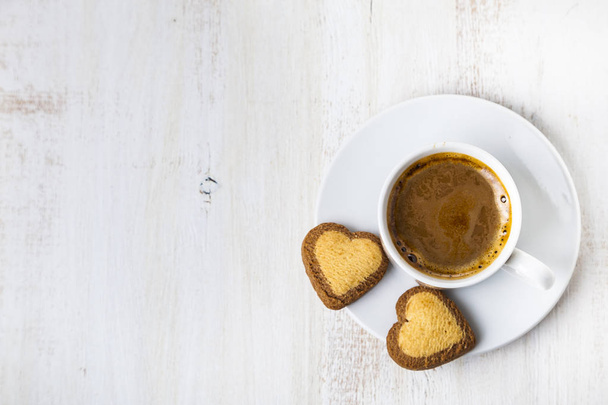 Heart-shaped biscuits and coffee - Фото, изображение