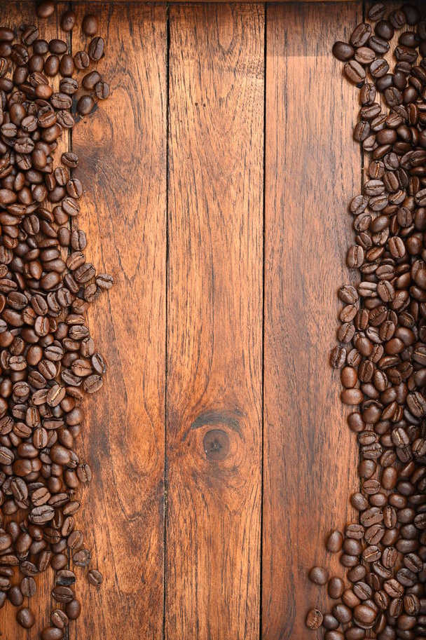 Close up of coffee beans on wooden background - Фото, изображение