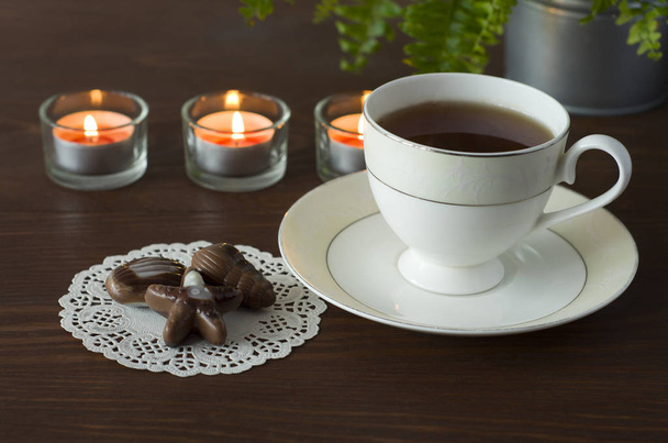 朝には、木製のテーブルの上の素敵なコーヒーとおいしいチョコレート - 写真・画像