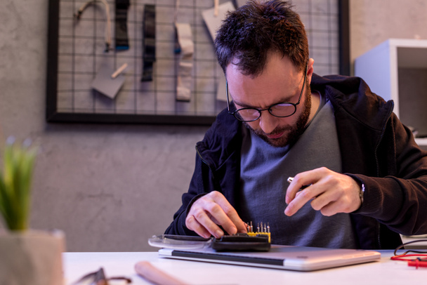 man choosing attachments to screwdriver over digital tablet  - Fotoğraf, Görsel