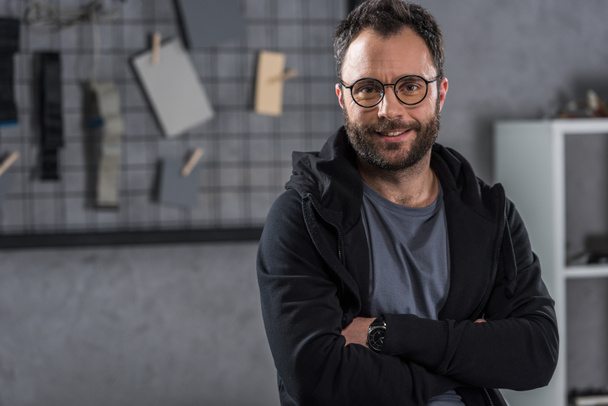 smiling man with glasses  looking at camera with arms crossed - Fotografie, Obrázek