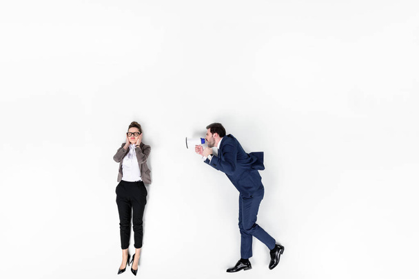 top view of boss shouting at manager with loudspeaker isolated on white - Foto, immagini