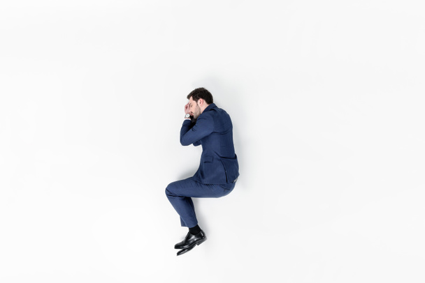top view of young businessman sleeping in suit isolated on white - Φωτογραφία, εικόνα