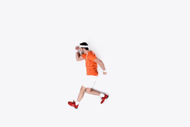 top view of young man in sportswear running isolated on white - Φωτογραφία, εικόνα