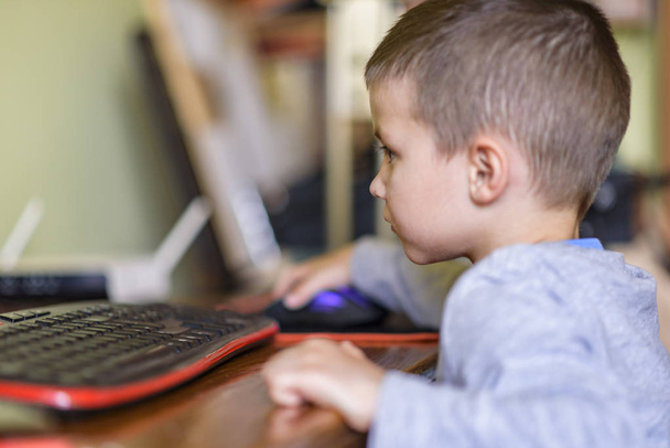 Young boy playing games on a desktop computer - Photo, Image