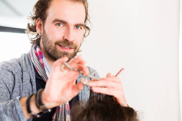 Barber cutting man hair in haircutter shop - Photo, Image