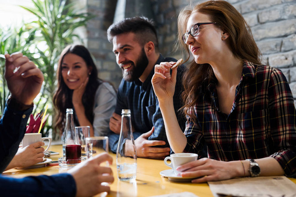 Happy young friends hangout together in coffee shop - Photo, Image