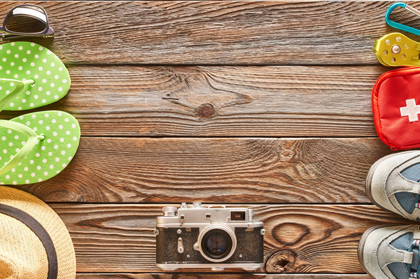 Travel items for beach rest and hike. Still life over wooden background with copy space - Photo, Image