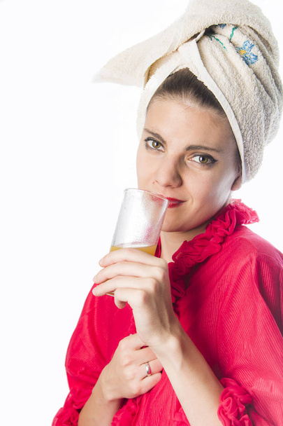 Girl in bathrobes drinking orange juice - Fotoğraf, Görsel
