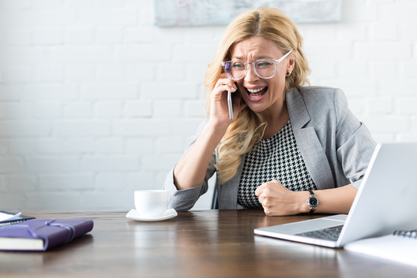 sorprendido gritando mujer de negocios hablando por teléfono inteligente en la oficina
 - Foto, Imagen