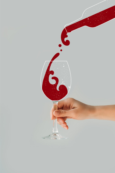 Cropped image of woman holding wine glass in her hand isolated on gray - Foto, imagen