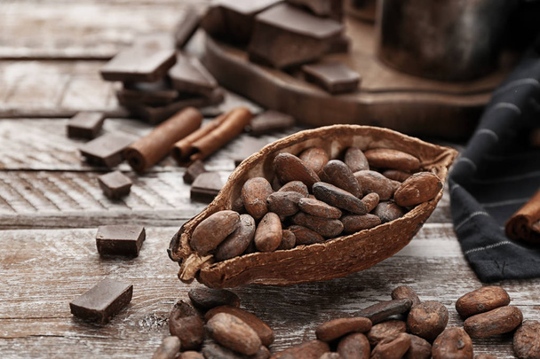Composition with cocoa pod and beans on wooden table - Photo, image