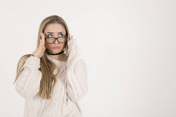 young girl with long hair in glasses and a white knitted sweater - Foto, imagen