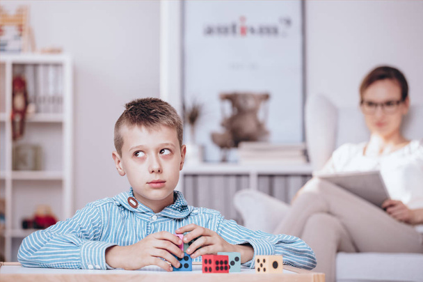 Boy playing with dice - Фото, изображение