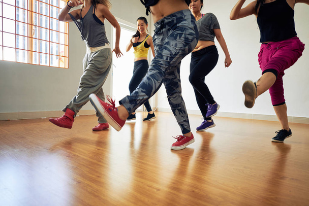 women practicing hip hop dance choreography in studio room - Photo, Image