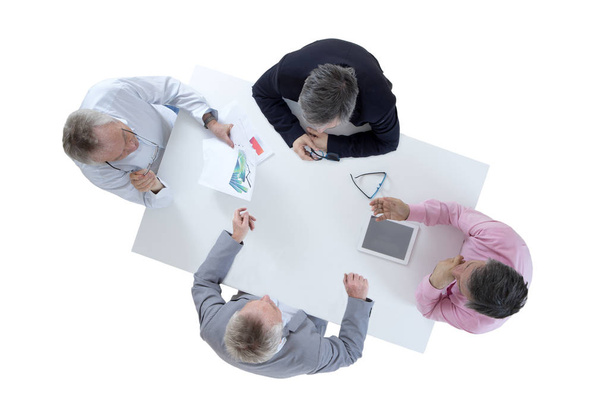 Bovenste weergave van mensen uit het bedrijfsleven rond tafel met papierwerk op wit - Foto, afbeelding