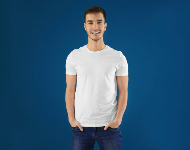 Young man in stylish t-shirt on color background. Mockup for design - Foto, Imagem