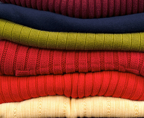 Stack of rainbow colored sweaters.  - Фото, зображення